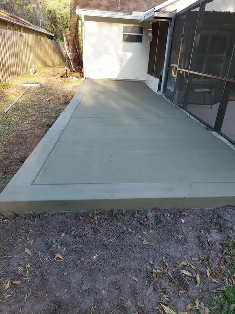 Concrete slab poured beside a screened lanai