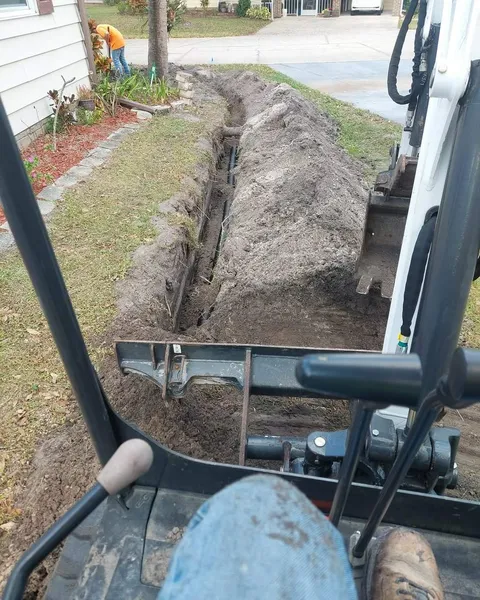Mini excavator digging a utility trench