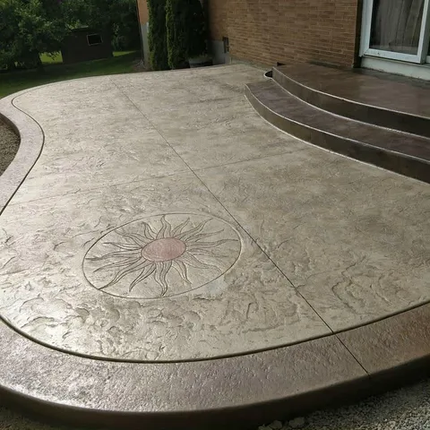Stamped concrete patio with custom sun medallion